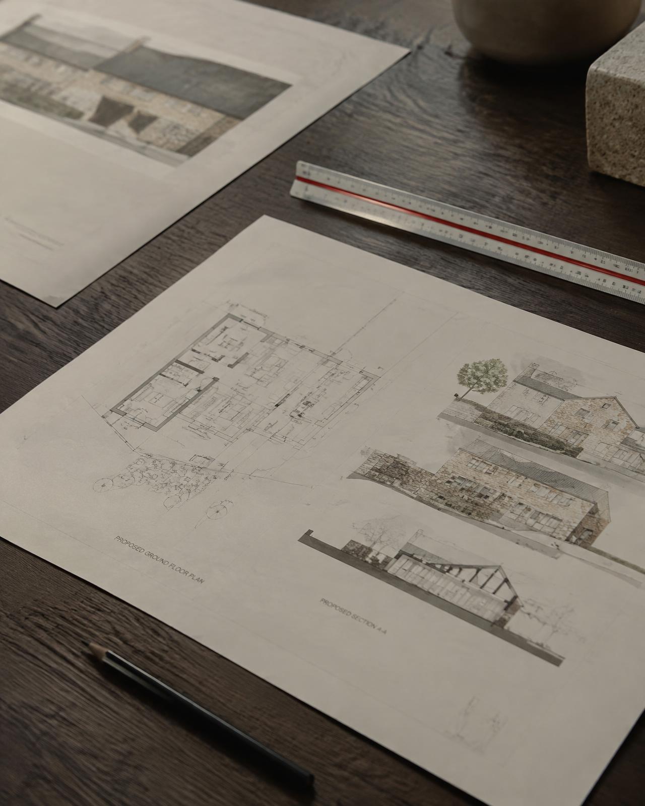 Architectural extension drawings on an oak table
